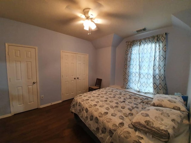 bedroom featuring ceiling fan, lofted ceiling, baseboards, a closet, and dark wood-style floors