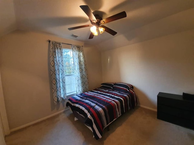 bedroom with carpet flooring, a ceiling fan, visible vents, vaulted ceiling, and baseboards