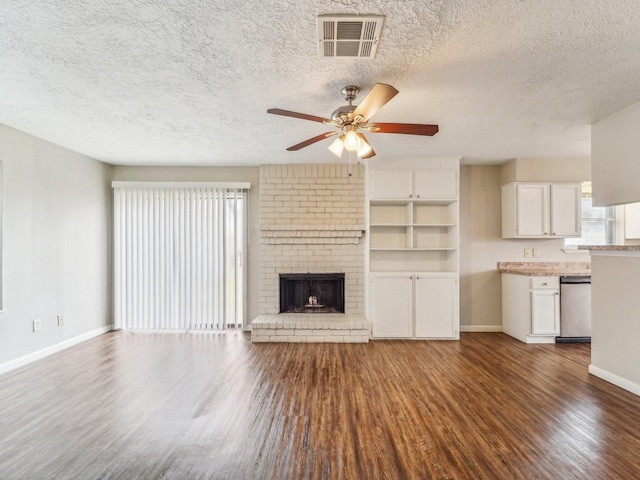 unfurnished living room with baseboards, a fireplace, visible vents, and dark wood finished floors