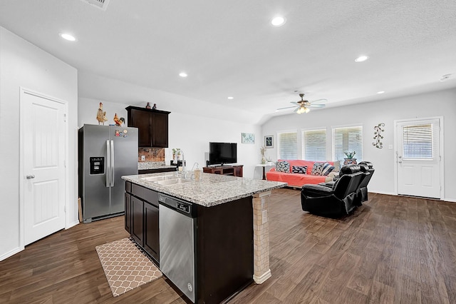 kitchen with recessed lighting, dark wood-type flooring, a sink, open floor plan, and appliances with stainless steel finishes