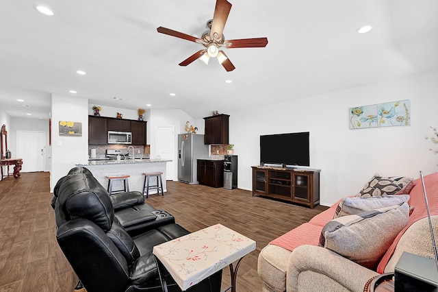 living area featuring ceiling fan, wood finished floors, and recessed lighting