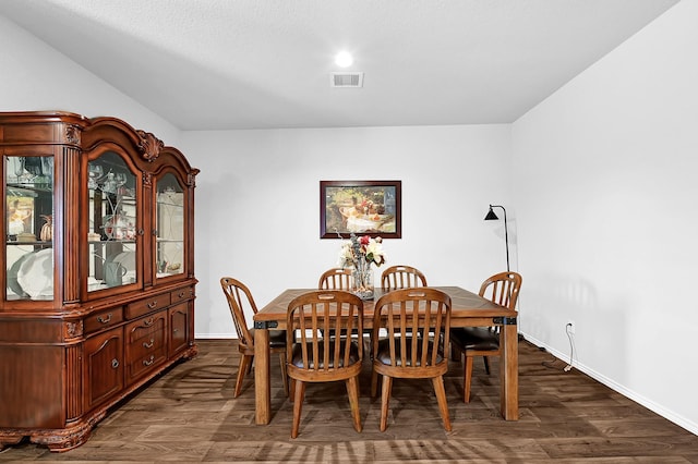 dining room with visible vents, dark wood finished floors, and baseboards