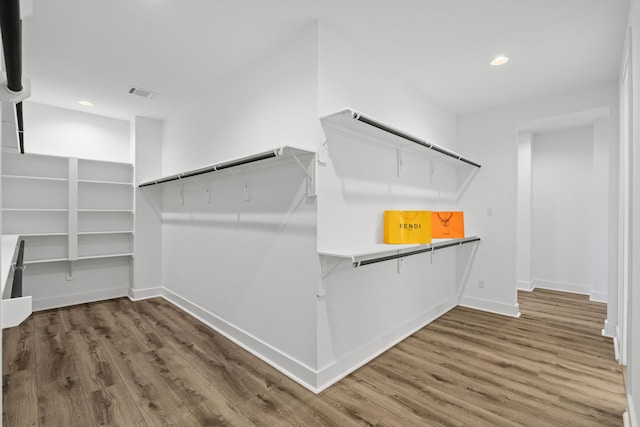 spacious closet with wood finished floors and visible vents