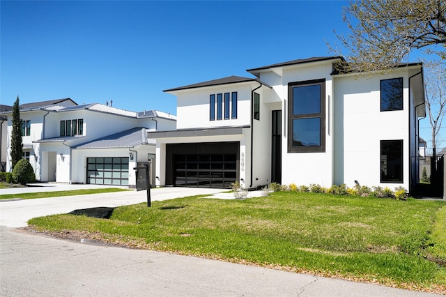 modern home with stucco siding, a garage, concrete driveway, and a front lawn