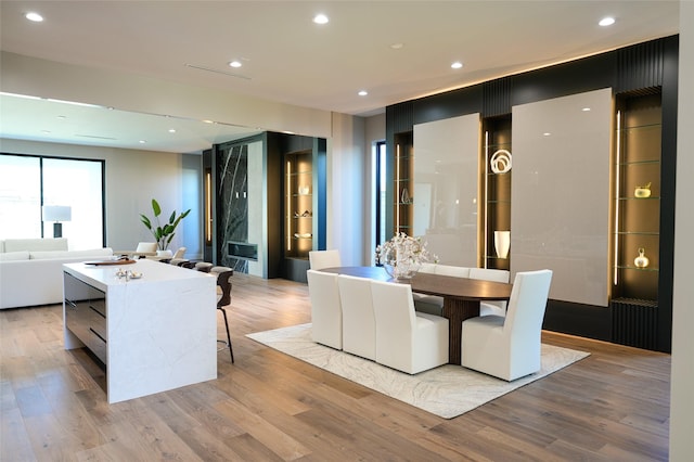 dining room with light wood-style flooring and recessed lighting