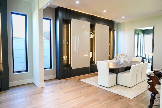 dining space with recessed lighting, baseboards, and light wood finished floors