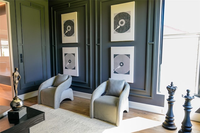 sitting room featuring baseboards and wood finished floors