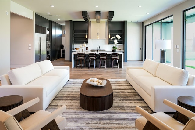 living room with recessed lighting and light wood finished floors