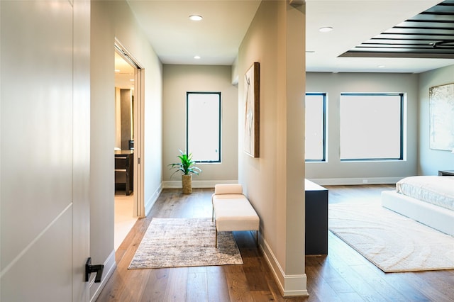 interior space featuring recessed lighting, baseboards, and hardwood / wood-style flooring