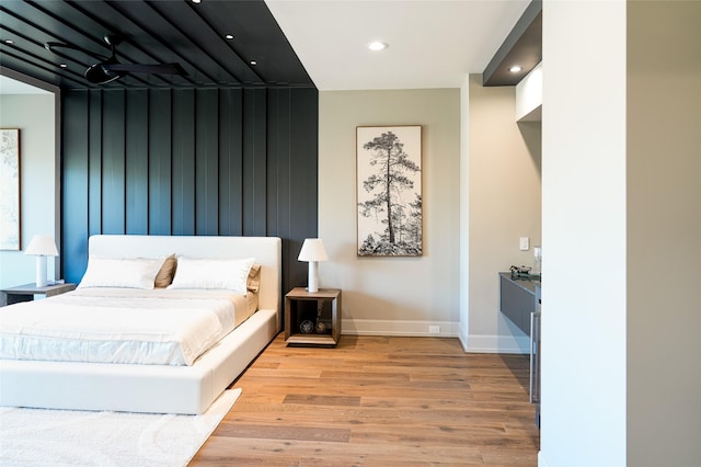 bedroom with recessed lighting, baseboards, and wood finished floors