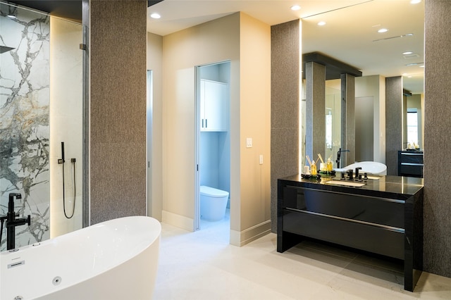 full bathroom featuring baseboards, a freestanding bath, toilet, recessed lighting, and vanity