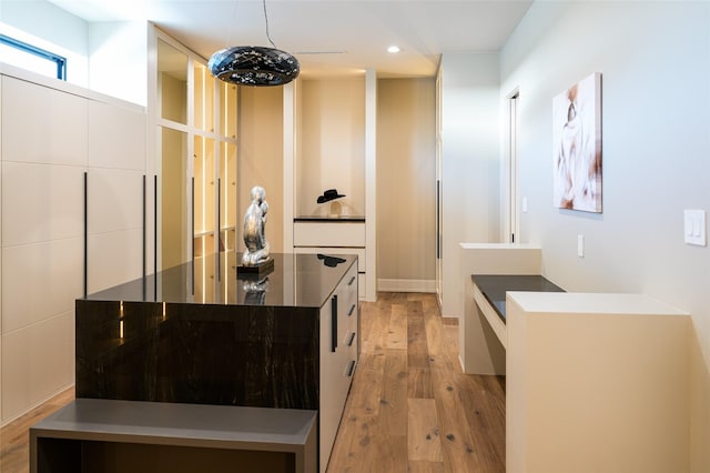 kitchen with a center island, recessed lighting, light wood-style floors, white cabinetry, and modern cabinets