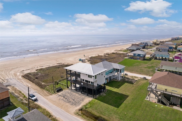 aerial view with a water view and a beach view