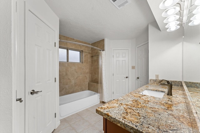 full bathroom with visible vents, vanity, a textured ceiling, shower / bathtub combination, and a closet