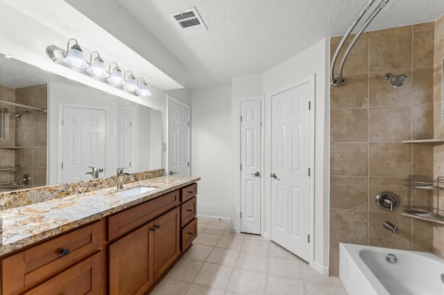 full bath with a textured ceiling, tile patterned flooring, bathtub / shower combination, vanity, and visible vents