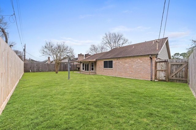 view of yard with a fenced backyard