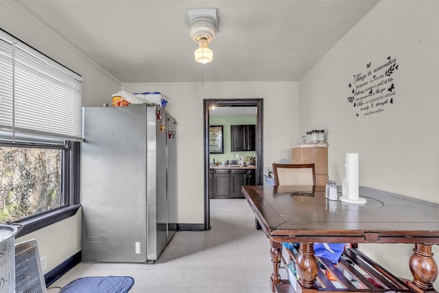 dining room with light tile patterned floors and baseboards