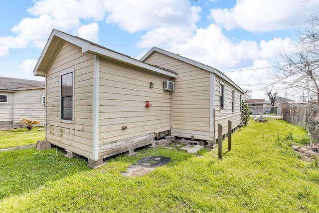 view of property exterior featuring a lawn and fence