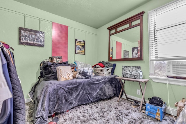 bedroom featuring cooling unit and baseboards