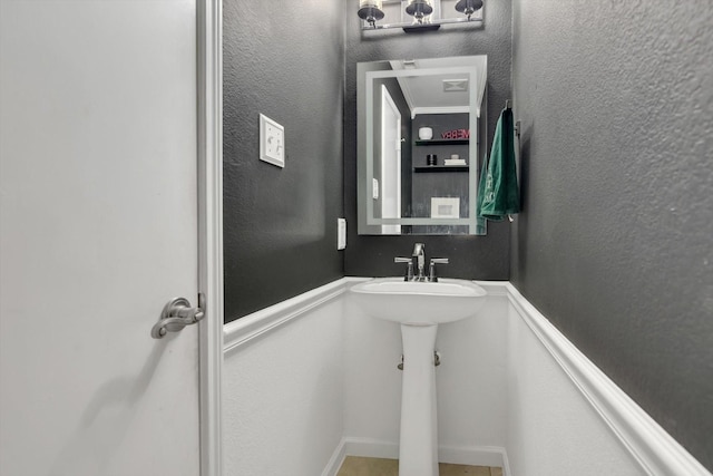 bathroom with a textured wall