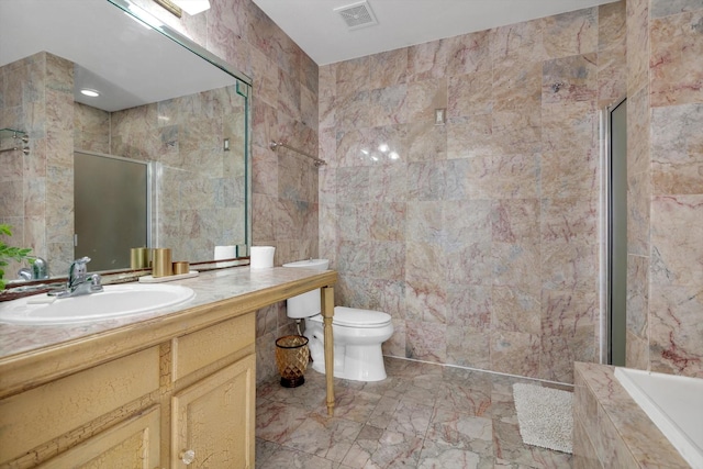 bathroom with toilet, visible vents, tile walls, and tiled shower