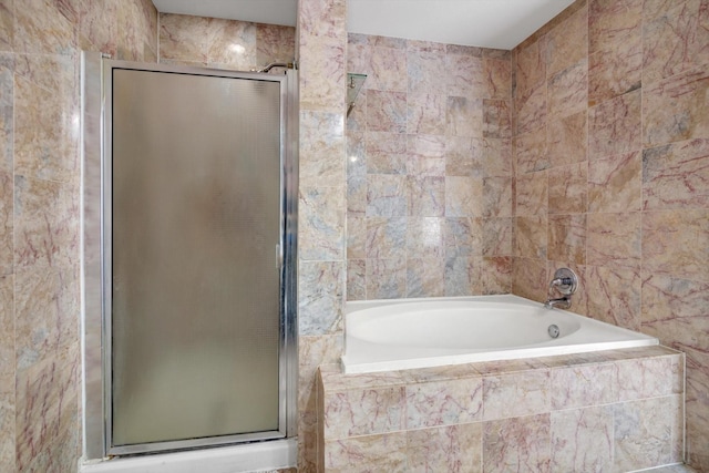 full bath with a stall shower, a garden tub, and tile walls