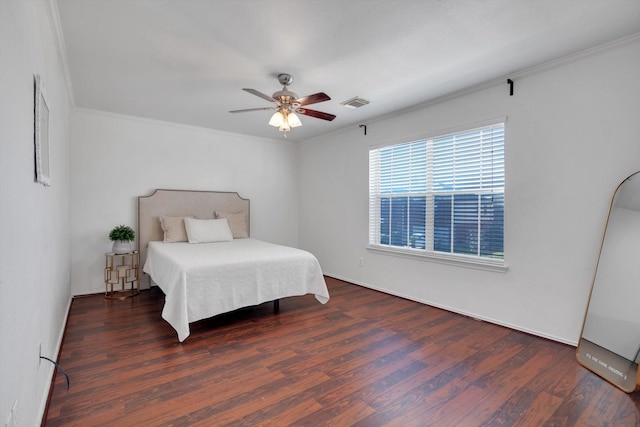 bedroom with crown molding, visible vents, ceiling fan, and wood finished floors