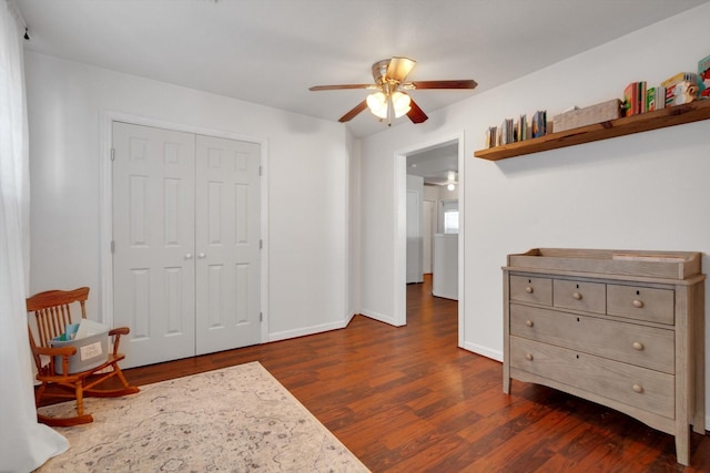 interior space featuring dark wood-type flooring, ceiling fan, and baseboards