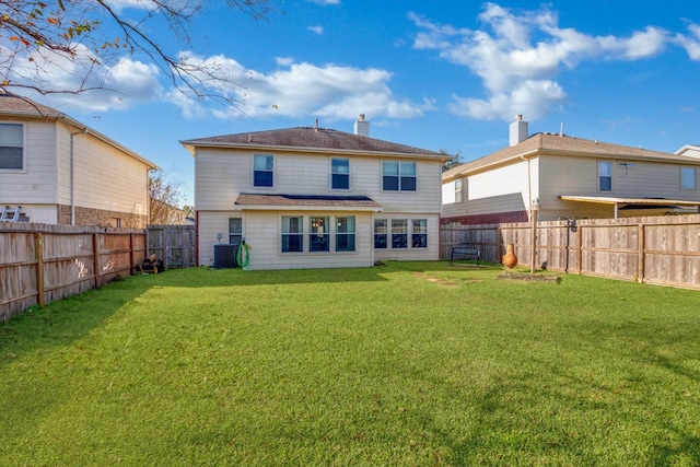 back of house with cooling unit, a fenced backyard, a yard, and a chimney