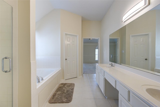 full bath featuring a sink, a shower stall, a bath, tile patterned floors, and double vanity