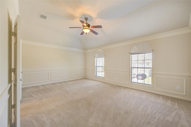 spare room with carpet floors, visible vents, and lofted ceiling