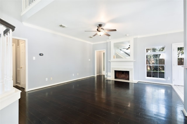 unfurnished living room with baseboards, visible vents, a fireplace with flush hearth, ornamental molding, and wood finished floors