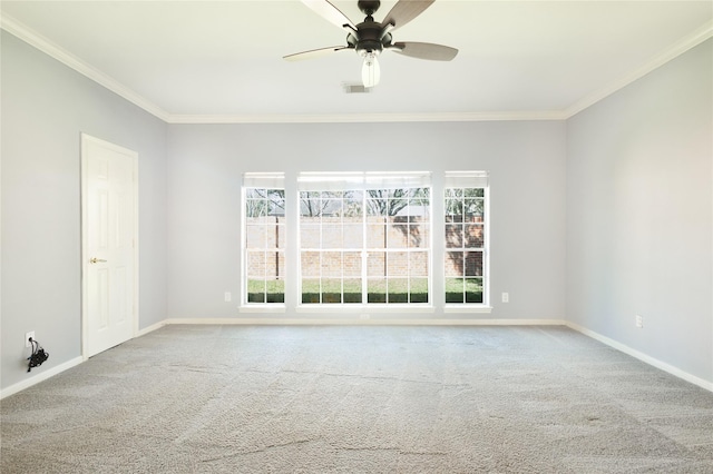 spare room featuring plenty of natural light, crown molding, and baseboards