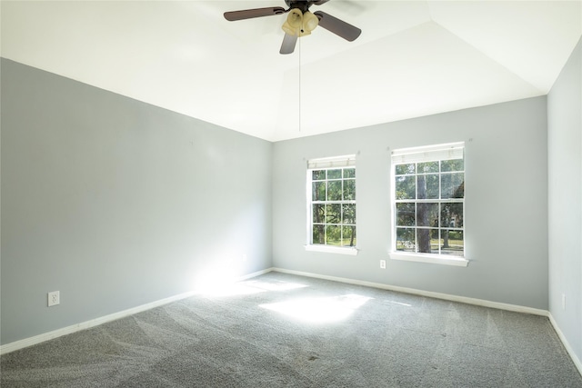 carpeted empty room with vaulted ceiling, baseboards, and ceiling fan