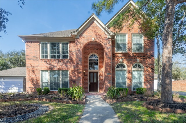 view of front of property with a garage and brick siding