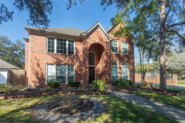 view of front of home with fence and brick siding