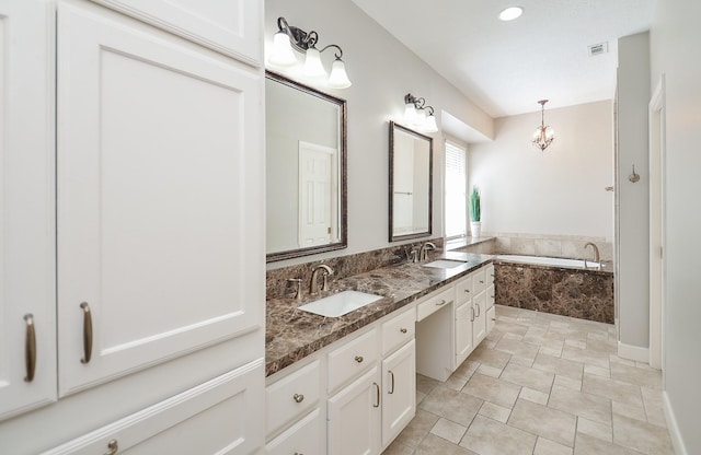 full bath featuring double vanity, a bath, visible vents, and a sink