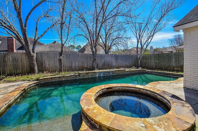 view of swimming pool with a fenced in pool, an in ground hot tub, and a fenced backyard