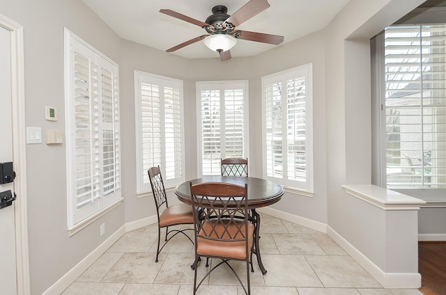 dining area featuring light tile patterned floors, baseboards, and ceiling fan