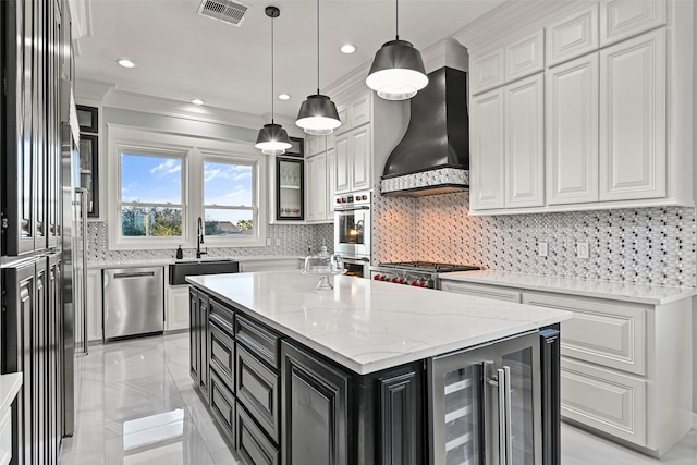 kitchen with visible vents, appliances with stainless steel finishes, beverage cooler, dark cabinetry, and wall chimney exhaust hood