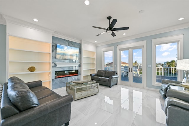 living room featuring built in shelves, a premium fireplace, crown molding, and recessed lighting