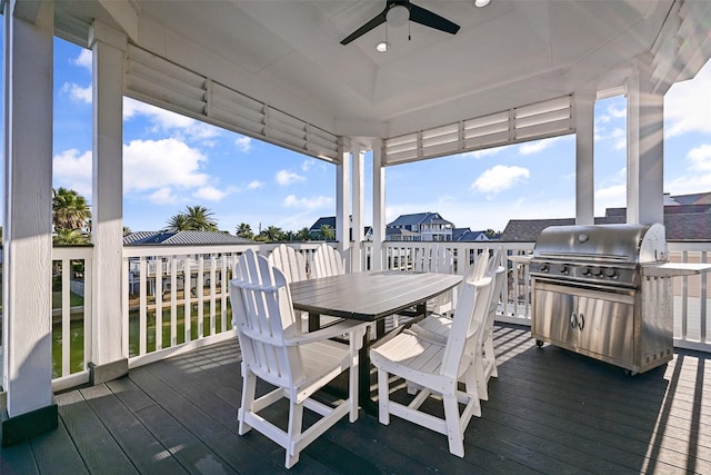 wooden deck featuring outdoor dining space and ceiling fan