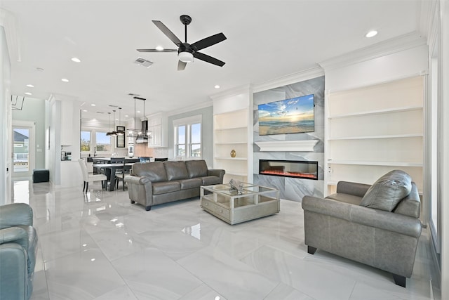 living area with ceiling fan, recessed lighting, a fireplace, visible vents, and crown molding