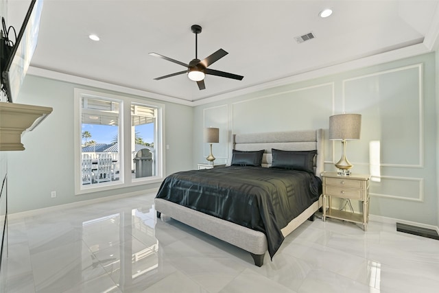 bedroom featuring crown molding, baseboards, visible vents, and a decorative wall