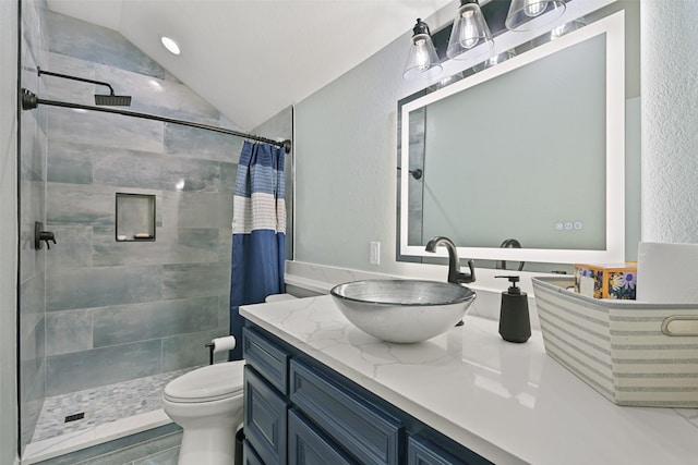 full bath with a stall shower, a textured wall, toilet, vaulted ceiling, and vanity