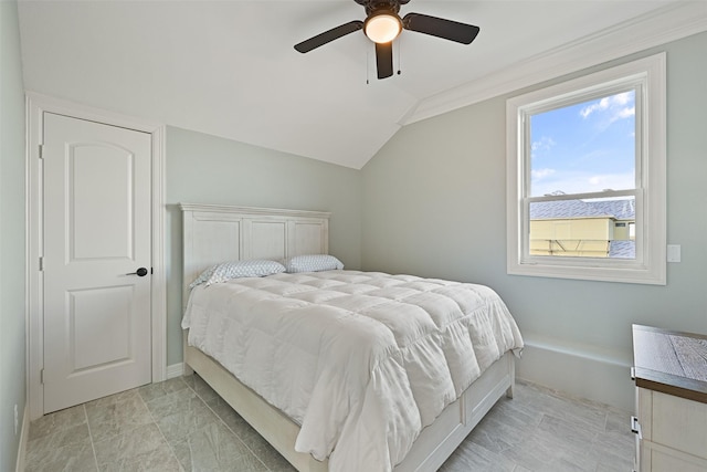 bedroom with a ceiling fan and vaulted ceiling