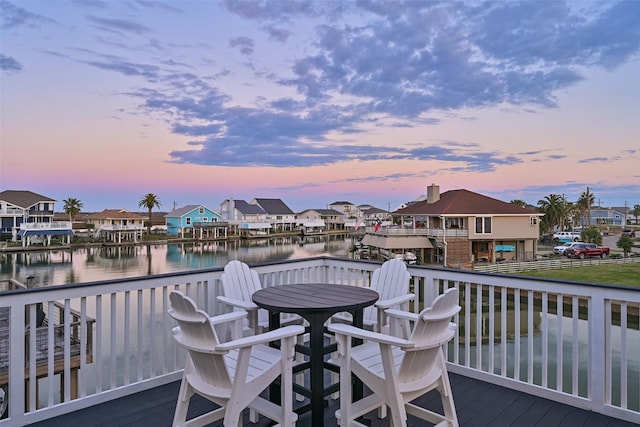 wooden deck featuring a residential view and a water view