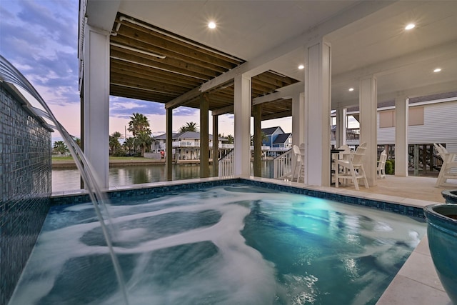 view of swimming pool with a water view