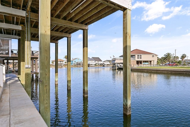 dock area with a water view and a residential view