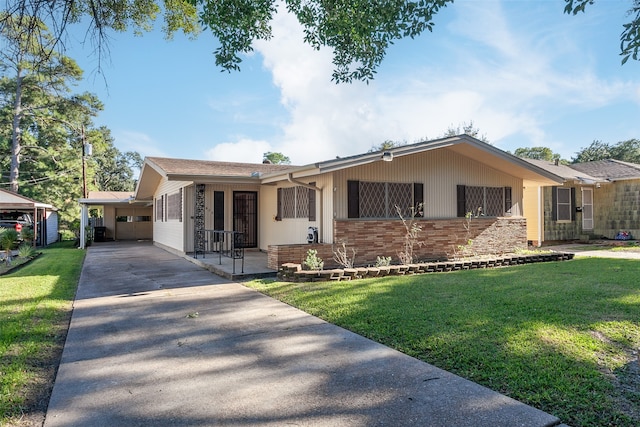 ranch-style home with a front yard, brick siding, and driveway